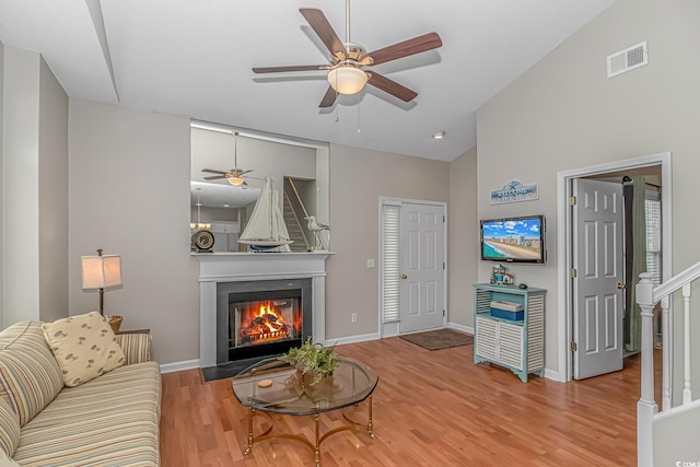 503 20th Ave N Unit 15B, North Myrtle Beach, SC 29582 - living room featuring a glass covered fireplace, wood finished floors, ceiling fan, baseboards, and high vaulted ceiling