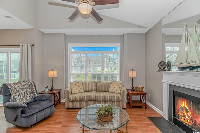 503 20th Ave N Unit 15B, North Myrtle Beach, SC 29582 - living area with ceiling fan, light wood finished floors, vaulted ceiling, a high end fireplace, and baseboards