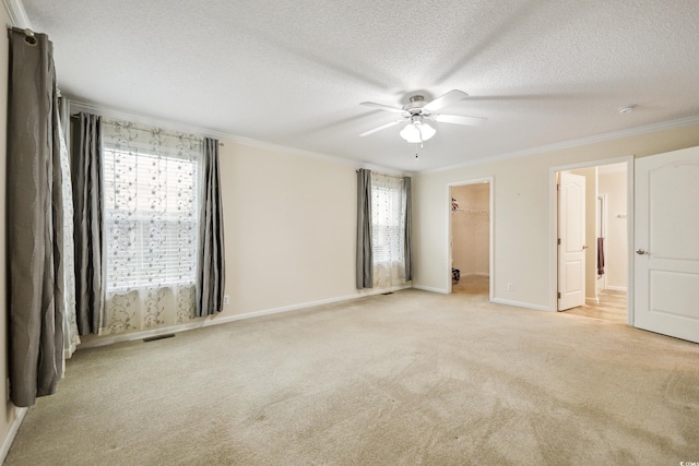 263 Walden Lake Rd, Conway, SC 29526 - unfurnished bedroom featuring light carpet, a walk in closet, baseboards, ornamental molding, and a textured ceiling
