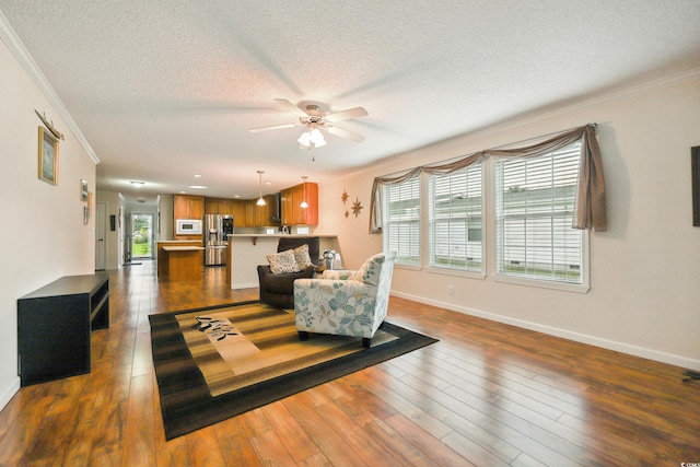 263 Walden Lake Rd, Conway, SC 29526 - living area featuring crown molding, a textured ceiling, baseboards, ceiling fan, and dark wood-type flooring