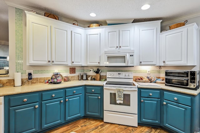 356 Lakeside Crossing Dr, Conway, SC 29526 - kitchen with white appliances, white cabinetry, crown molding, light countertops, and blue cabinets
