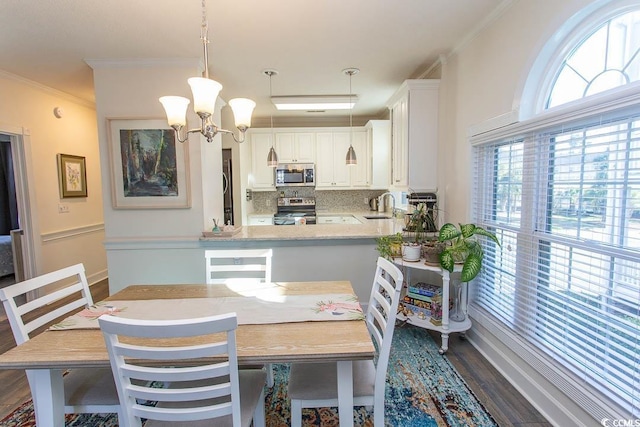 690 Riverwalk Dr Unit 201, Myrtle Beach, SC 29579 - dining space with dark wood-type flooring, ornamental molding, and a chandelier
