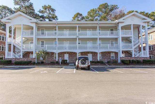690 Riverwalk Dr Unit 201, Myrtle Beach, SC 29579 - view of property with stairway and uncovered parking