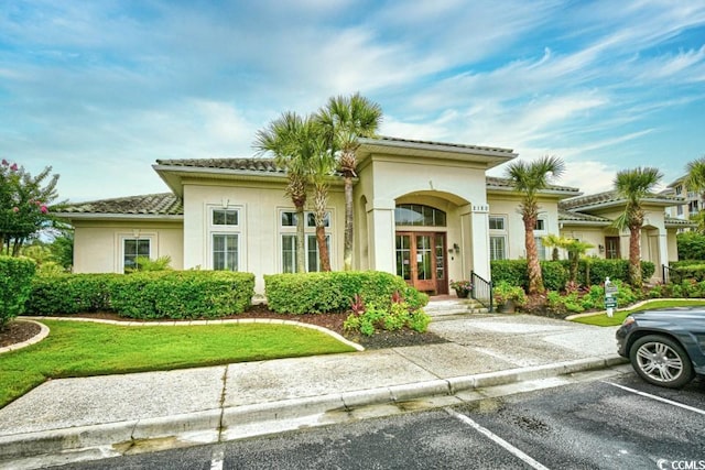 2180 Waterview Dr Unit 635, North Myrtle Beach, SC 29582 - view of front of house with french doors, uncovered parking, stucco siding, and a front lawn