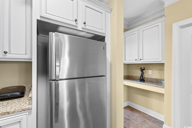 788 Gabreski Ln Unit B4, Myrtle Beach, SC 29577 - kitchen featuring freestanding refrigerator, light stone counters, crown molding, white cabinetry, and baseboards