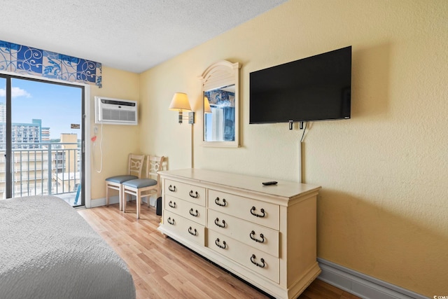 1207 S Ocean Blvd Unit 51001, Myrtle Beach, SC 29577 - bedroom with access to exterior, multiple windows, light wood-type flooring, a textured ceiling, and a view of city