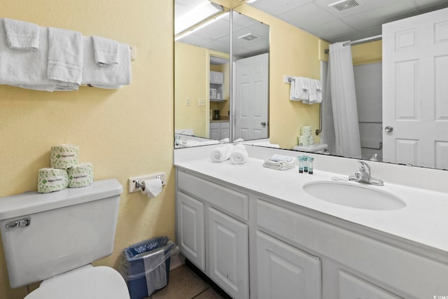 1207 S Ocean Blvd Unit 51001, Myrtle Beach, SC 29577 - full bathroom with toilet, a drop ceiling, vanity, a shower with curtain, and tile patterned flooring