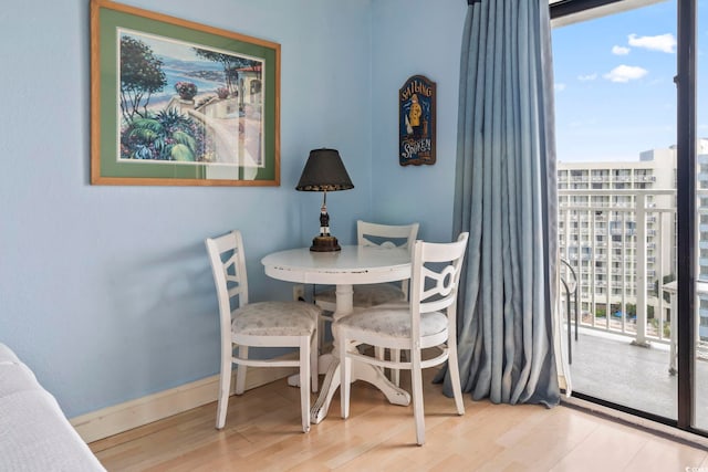 1207 S Ocean Blvd Unit 51312, Myrtle Beach, SC 29577 - dining area with healthy amount of natural light, wood finished floors, and baseboards