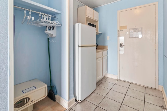 1207 S Ocean Blvd Unit 51312, Myrtle Beach, SC 29577 - kitchen with freestanding refrigerator, open shelves, light countertops, light tile patterned floors, and baseboards