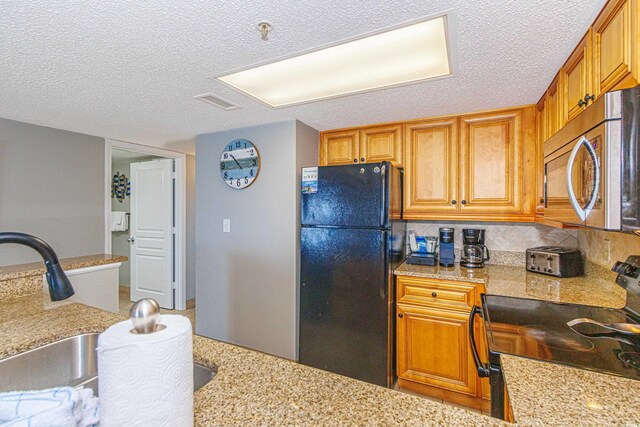 7100 N Ocean Blvd Unit 1421, Myrtle Beach, SC 29572 - kitchen with stainless steel microwave, freestanding refrigerator, range with electric cooktop, a textured ceiling, and backsplash