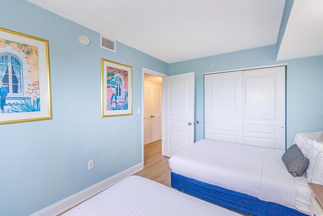 7100 N Ocean Blvd Unit 1421, Myrtle Beach, SC 29572 - bedroom with baseboards, wood finished floors, and a closet