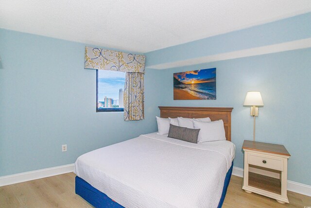 7100 N Ocean Blvd Unit 1421, Myrtle Beach, SC 29572 - bedroom featuring light wood-style floors and baseboards