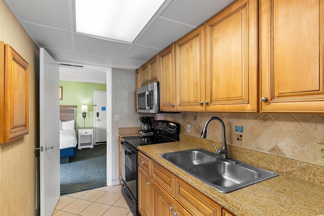 3000 N Ocean Blvd Unit 333, Myrtle Beach, SC 29577 - kitchen featuring black electric range oven, stainless steel microwave, a sink, brown cabinets, and light countertops