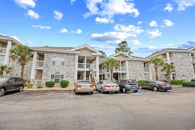 4767 Wild Iris Dr Unit 203, Myrtle Beach, SC 29579 - view of property with uncovered parking and stairs