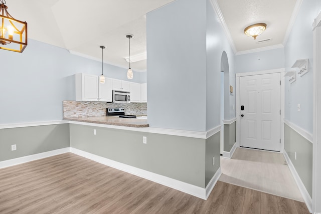 4767 Wild Iris Dr Unit 203, Myrtle Beach, SC 29579 - entrance foyer featuring arched walkways, ornamental molding, light wood finished floors, and baseboards