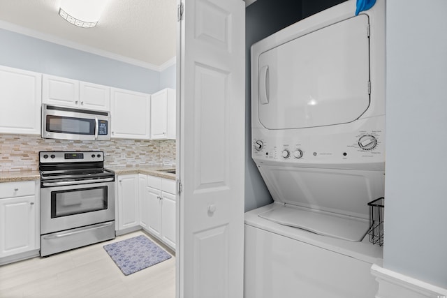 4767 Wild Iris Dr Unit 203, Myrtle Beach, SC 29579 - laundry room featuring estacked washer and dryer and ornamental molding
