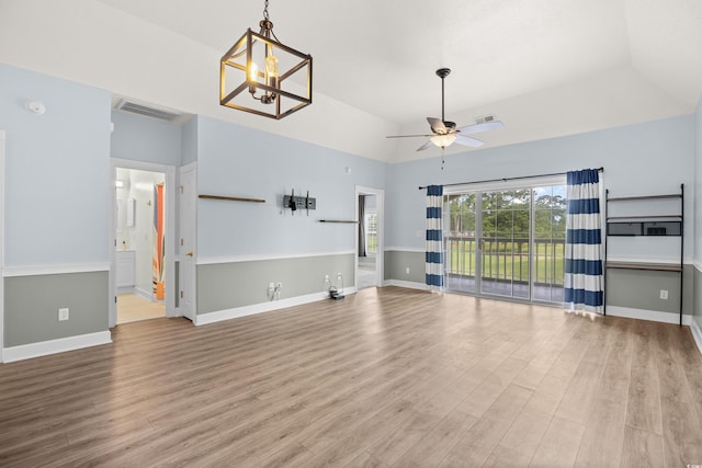 4767 Wild Iris Dr Unit 203, Myrtle Beach, SC 29579 - unfurnished living room with a ceiling fan, light wood-style flooring, lofted ceiling, a chandelier, and baseboards