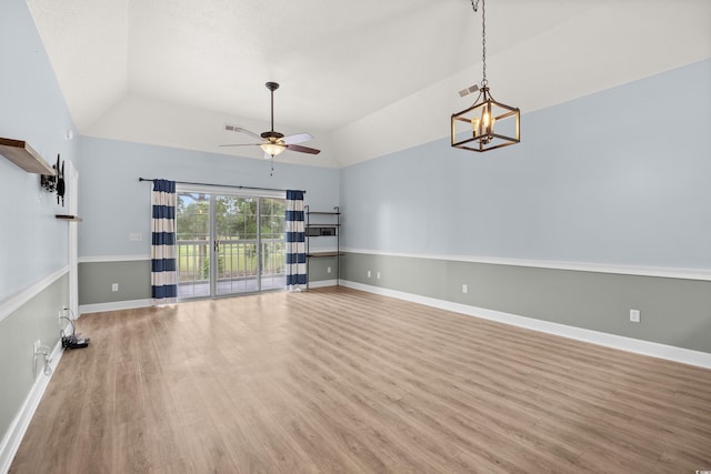 4767 Wild Iris Dr Unit 203, Myrtle Beach, SC 29579 - spare room with ceiling fan, lofted ceiling, light wood finished floors, a chandelier, and baseboards
