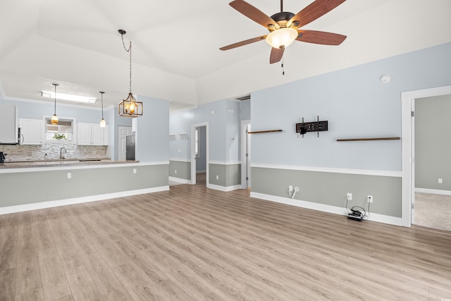 4767 Wild Iris Dr Unit 203, Myrtle Beach, SC 29579 - unfurnished living room featuring light wood-style floors, ceiling fan, and a sink