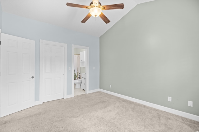4767 Wild Iris Dr Unit 203, Myrtle Beach, SC 29579 - unfurnished bedroom with light carpet, vaulted ceiling, connected bathroom, baseboards, and ceiling fan