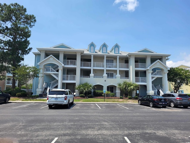 330 S Middleton Dr Unit 603, Calabash, NC 28467 - view of building exterior featuring uncovered parking and stairway