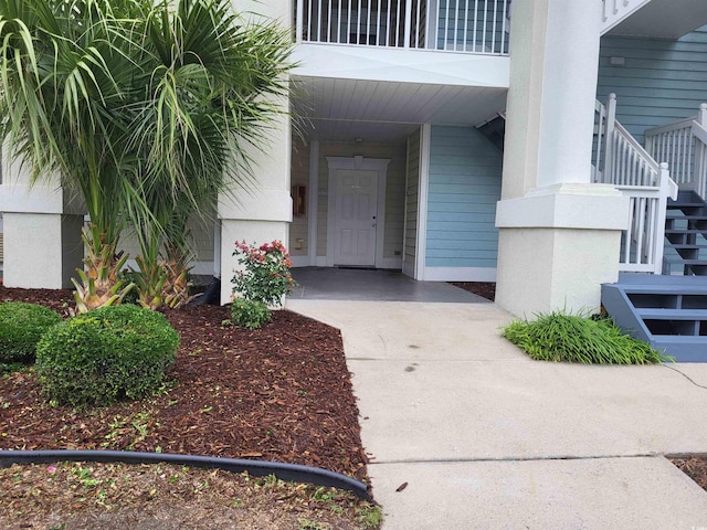 330 S Middleton Dr Unit 603, Calabash, NC 28467 - view of exterior entry featuring concrete driveway and a carport