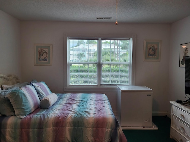 330 S Middleton Dr Unit 603, Calabash, NC 28467 - bedroom featuring multiple windows, a textured ceiling, and fridge
