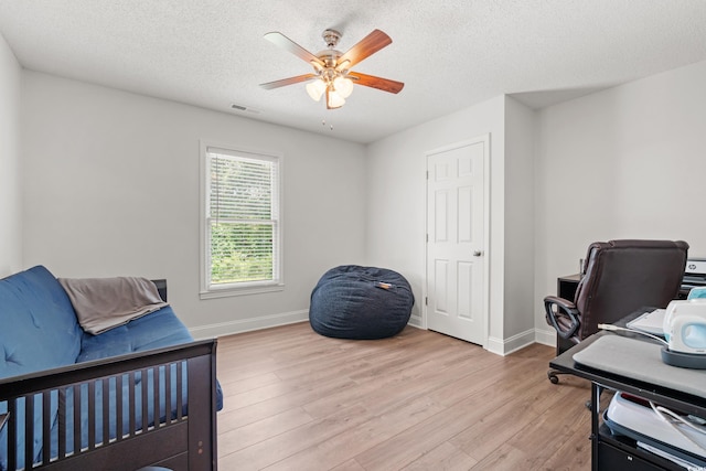 1936 Lees Landing Cir, Conway, SC 29526 - bedroom with light wood-style flooring, an office area, a textured ceiling, and ceiling fan