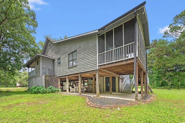 1936 Lees Landing Cir, Conway, SC 29526 - back of property featuring a patio area, stairs, a lawn, and a sunroom