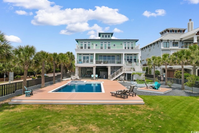 4900 N Ocean Blvd, Myrtle Beach, SC 29577 - rear view of house featuring a balcony, stairway, a deck, a pool with connected hot tub, and a patio
