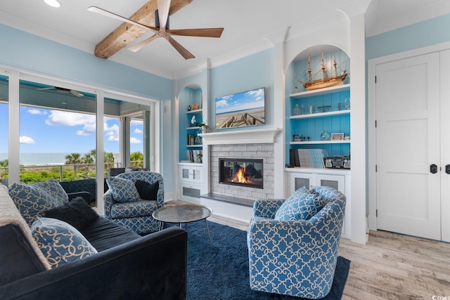 4900 N Ocean Blvd, Myrtle Beach, SC 29577 - living area with a ceiling fan, wood finished floors, a glass covered fireplace, and built in shelves