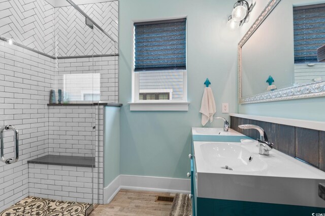 4900 N Ocean Blvd, Myrtle Beach, SC 29577 - bathroom featuring a shower stall, double vanity, and wood finished floors