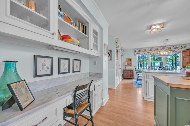 196 John Waites Ct, Georgetown, SC 29440 - office with built in study area, light wood-style flooring, a chandelier, and baseboards