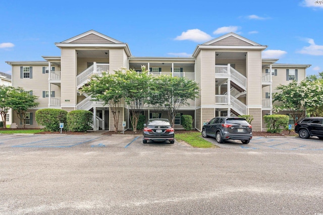 6016 Dick Pond Rd Unit 109, Myrtle Beach, SC 29588 - view of building exterior featuring uncovered parking and stairway