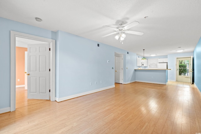 6016 Dick Pond Rd Unit 109, Myrtle Beach, SC 29588 - unfurnished living room with ceiling fan, baseboards, and light wood finished floors