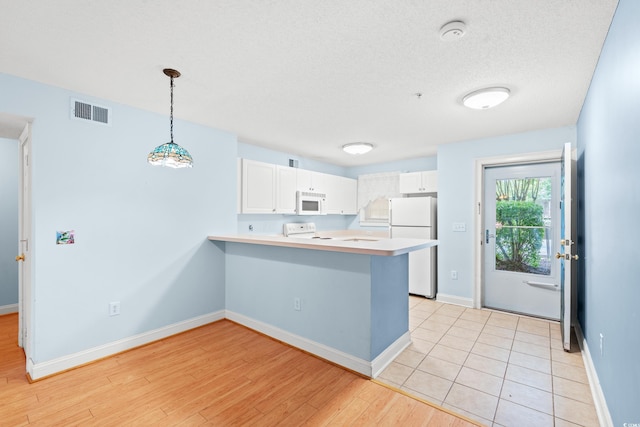 6016 Dick Pond Rd Unit 109, Myrtle Beach, SC 29588 - kitchen with white appliances, a peninsula, white cabinetry, light countertops, and baseboards