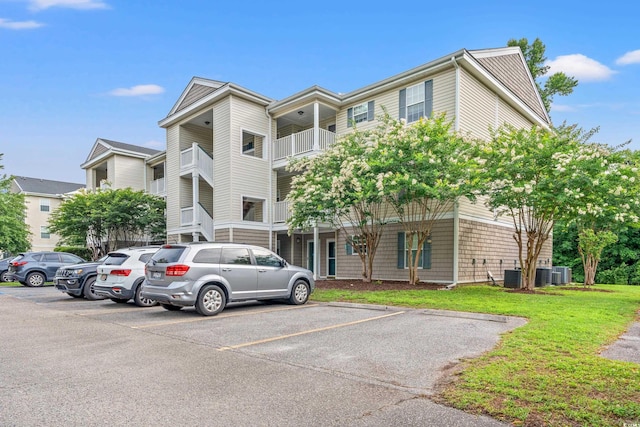 6016 Dick Pond Rd Unit 109, Myrtle Beach, SC 29588 - view of building exterior featuring uncovered parking and cooling unit