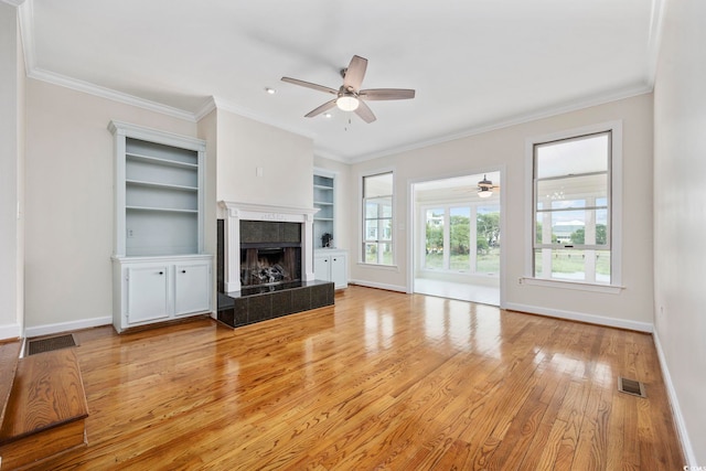 465 Vereen Rd Unit 10, Murrells Inlet, SC 29576 - unfurnished living room with a ceiling fan, light wood-style flooring, baseboards, a tile fireplace, and ornamental molding