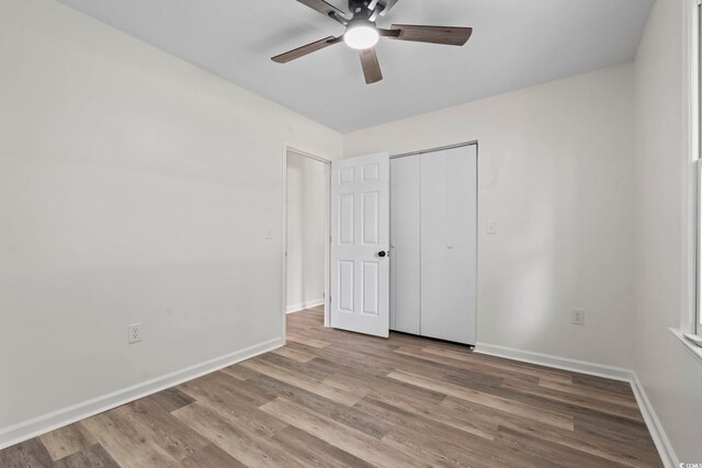 203 Deer Trce, Myrtle Beach, SC 29588 - unfurnished bedroom with wood finished floors, baseboards, a closet, and a ceiling fan