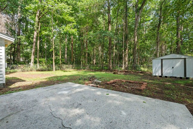 203 Deer Trce, Myrtle Beach, SC 29588 - fenced backyard with a patio area and a wooded view