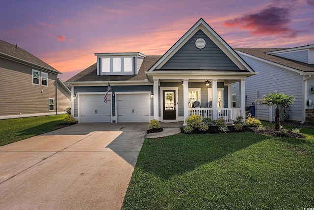 981 Mourning Dove Dr, Myrtle Beach, SC 29577 - view of front facade with a porch, an attached garage, a front yard, driveway, and a shingled roof