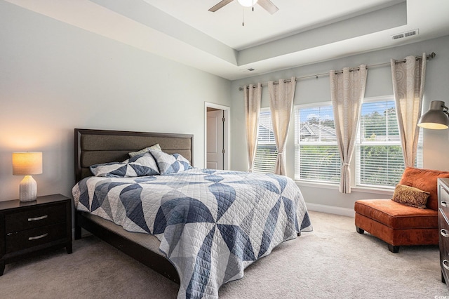 981 Mourning Dove Dr, Myrtle Beach, SC 29577 - bedroom featuring light carpet, a tray ceiling, baseboards, and ceiling fan