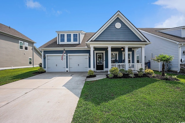 981 Mourning Dove Dr, Myrtle Beach, SC 29577 - view of front facade with a porch, a front yard, concrete driveway, roof with shingles, and a garage