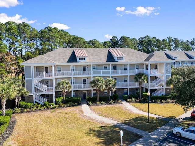 6253 Catalina Dr Unit 534, North Myrtle Beach, SC 29582 - view of property with uncovered parking and stairs