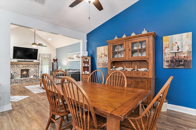 1904 Ronald Phillips Ave, Conway, SC 29527 - dining room with a ceiling fan, vaulted ceiling, a fireplace, wood finished floors, and baseboards