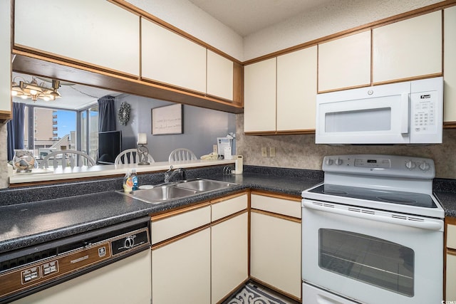 1425 S Ocean Blvd Unit 2A, North Myrtle Beach, SC 29582 - kitchen featuring white appliances, a sink, and dark countertops