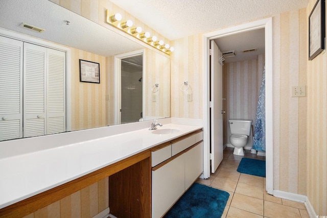 1425 S Ocean Blvd Unit 2A, North Myrtle Beach, SC 29582 - full bathroom with wallpapered walls, toilet, vanity, a textured ceiling, and tile patterned flooring