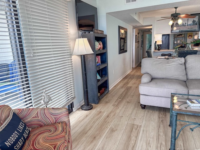 2101 S Ocean Blvd Unit A-4, North Myrtle Beach, SC 29582 - living room featuring ceiling fan, light wood-style flooring, and baseboards