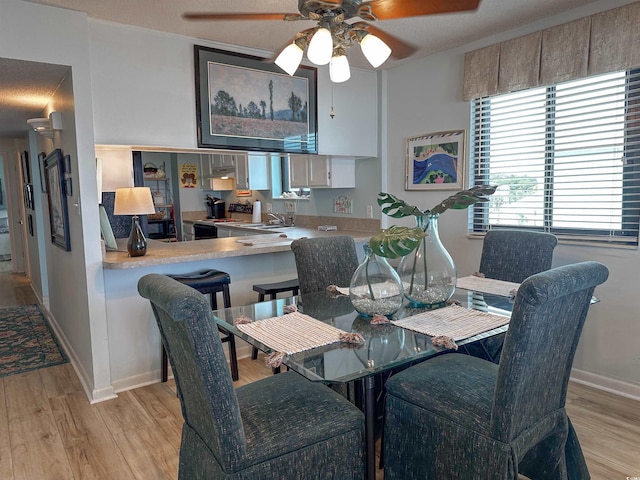 2101 S Ocean Blvd Unit A-4, North Myrtle Beach, SC 29582 - dining room featuring light wood-type flooring, a ceiling fan, and baseboards
