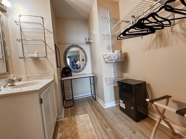 2101 S Ocean Blvd Unit A-4, North Myrtle Beach, SC 29582 - washroom with a sink, light wood finished floors, and baseboards